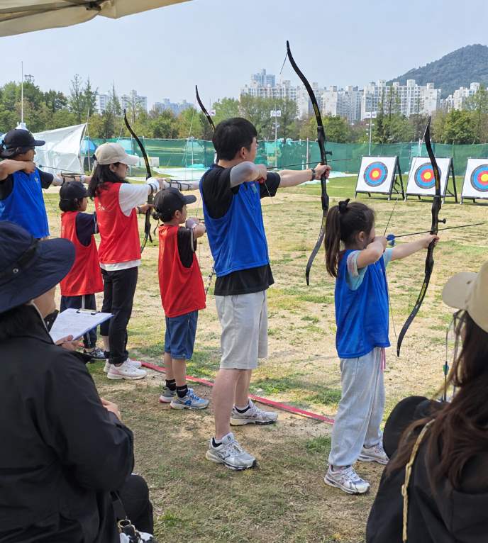 Yecheon Archery Festival teams of four competing with bows at Hancheon Sports Park