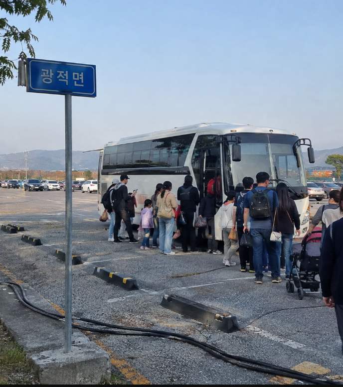 Yangju DroneBot Festival family waiting for an armored vehicle ride at Ganap-ri Airfield
